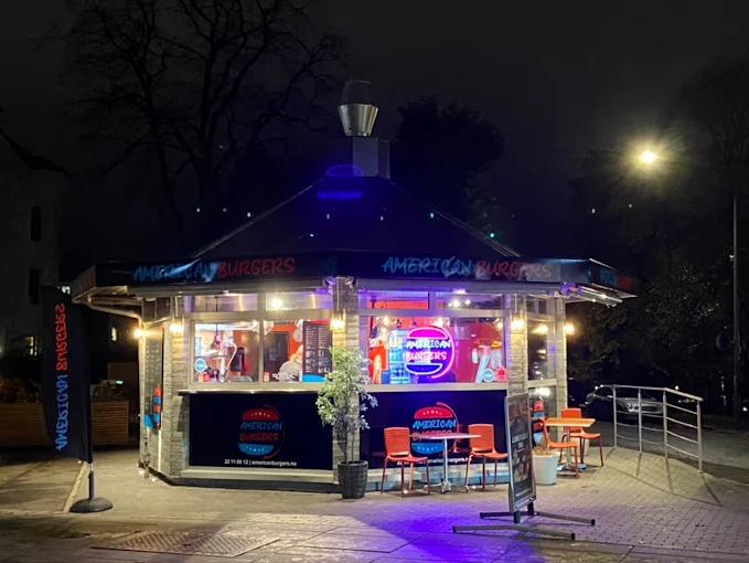 American Burgers kiosk lit up at night in Oslo
